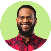 Smiling man with a beard wearing a red checkered shirt, representing customer satisfaction and trust in auto repair services at Route 40 Auto.